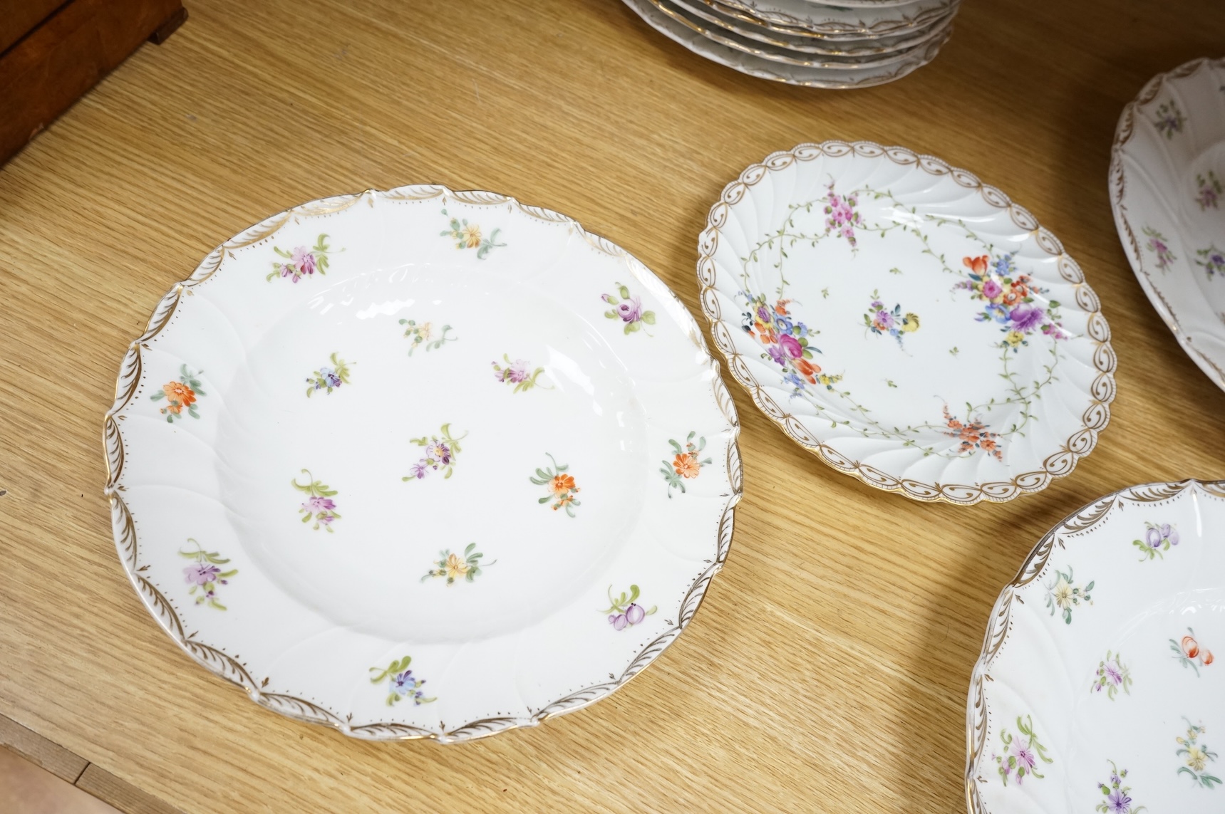 Eleven Dresden porcelain floral decorated plates(various sizes) and similar plate, two largest 31cm diameter.